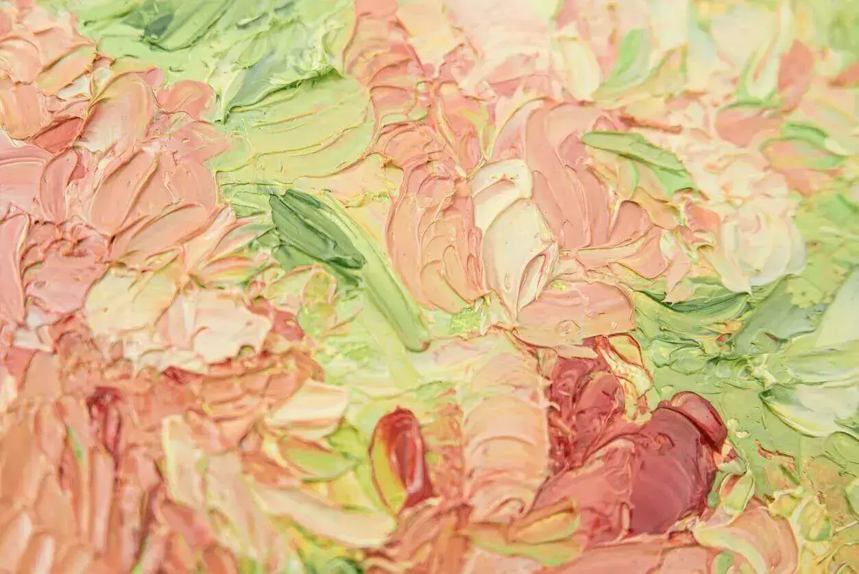 An oil painting canvas resembling pink and green flowers using many different textures and strokes.